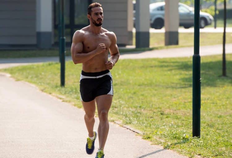 Bodybuilder Running in Park