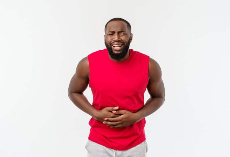 Man With Hand On Stomach