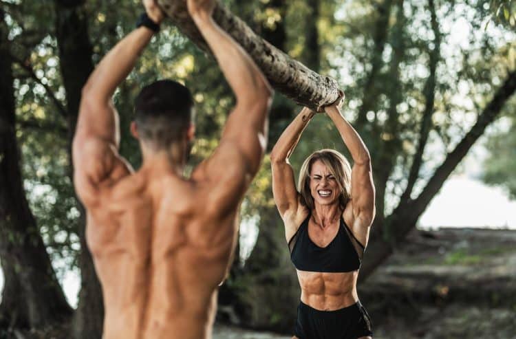 Muscular Female And Male Doing Hard Exercises