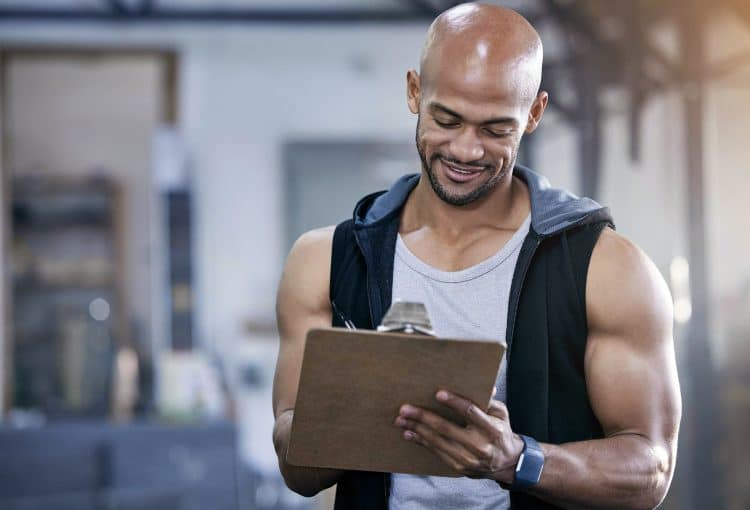Muscular Young Man Writing Notes