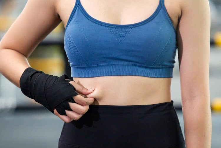 Woman Grabbing On Her Stomach Belly